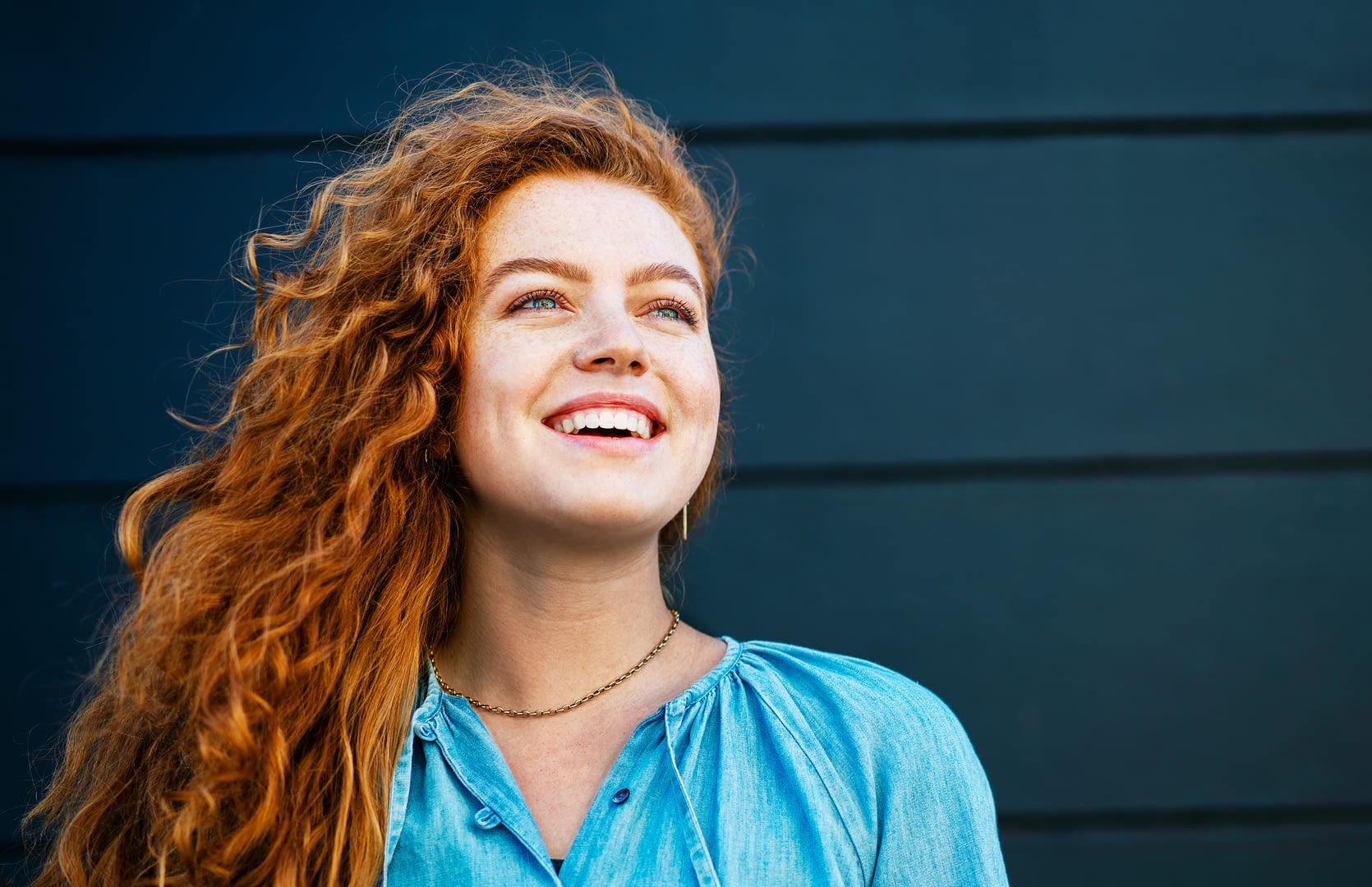 Young woman looking up smiling
