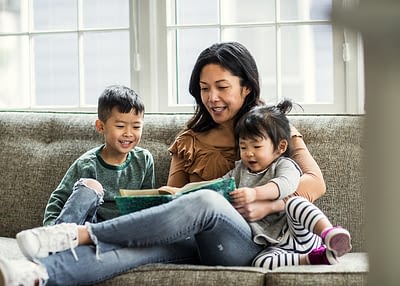 Mother reading to kids on couch Encouragement for Mothers