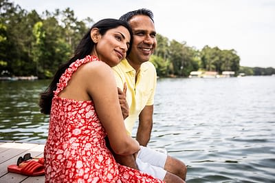 Husband and wife sitting on dock at lake Encouragement for Wives