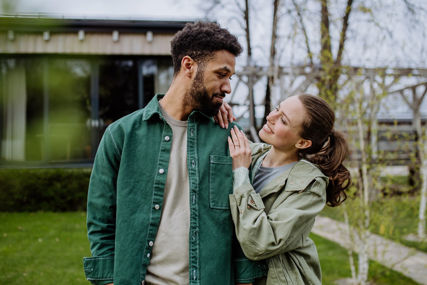 Young multiracial couple enjoying together time and freedom, outdoor in front of their house.