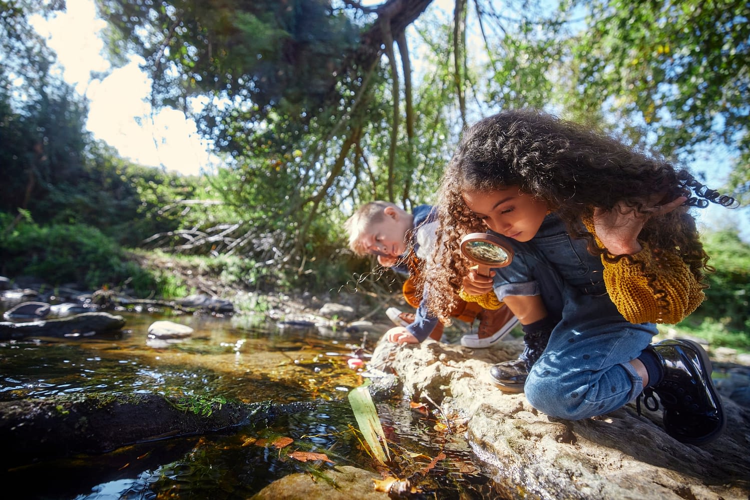 Small boy and girl looking at river