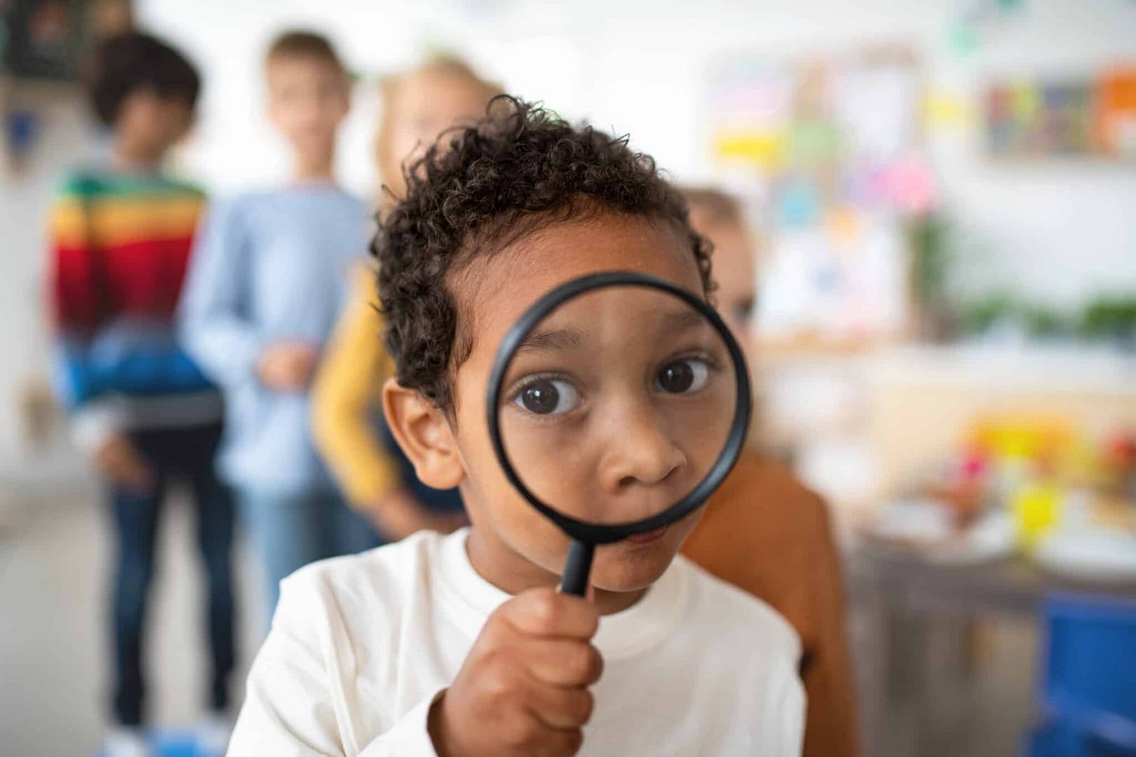 toddler boy with magnifying glass