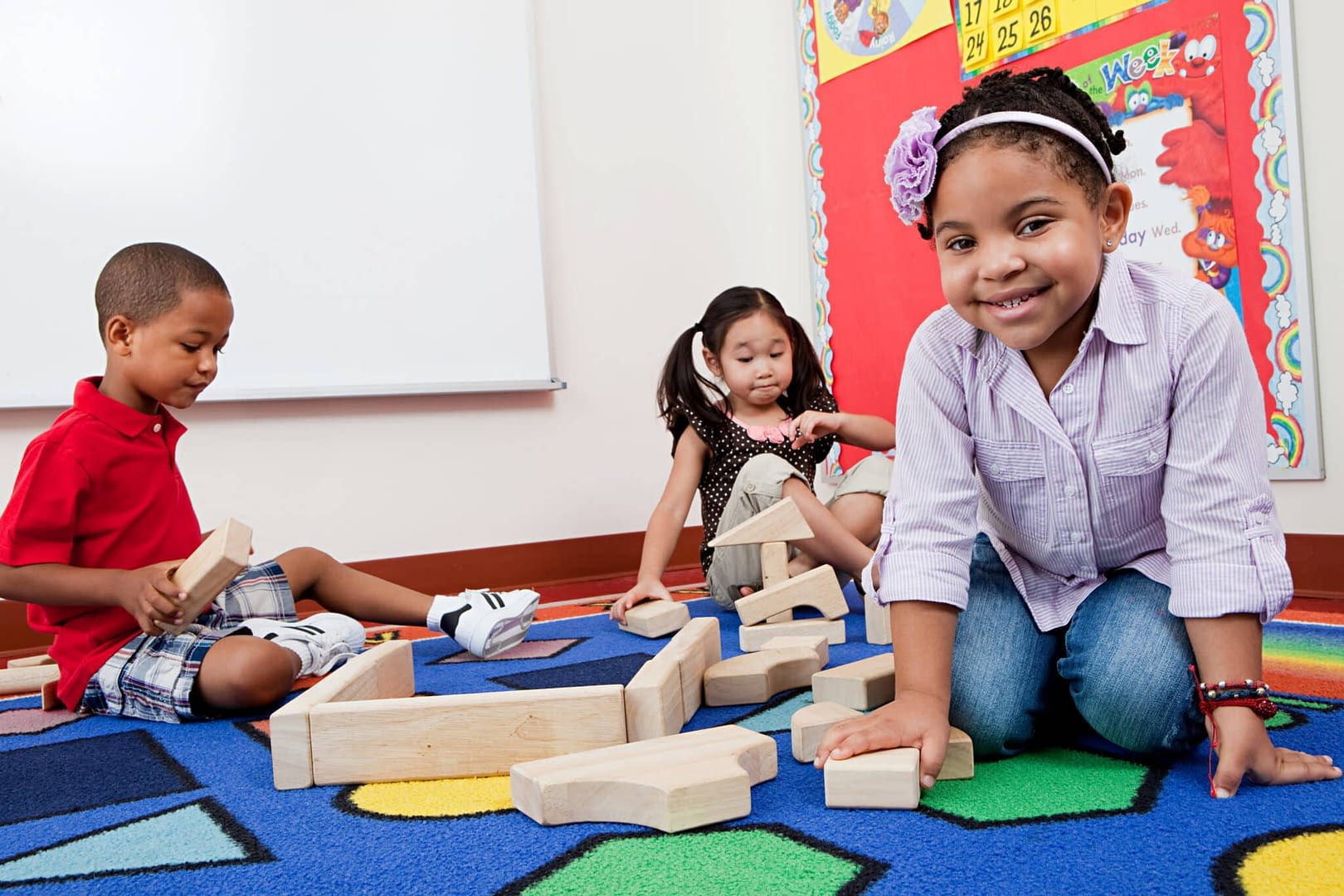 Children on floor with building blocks