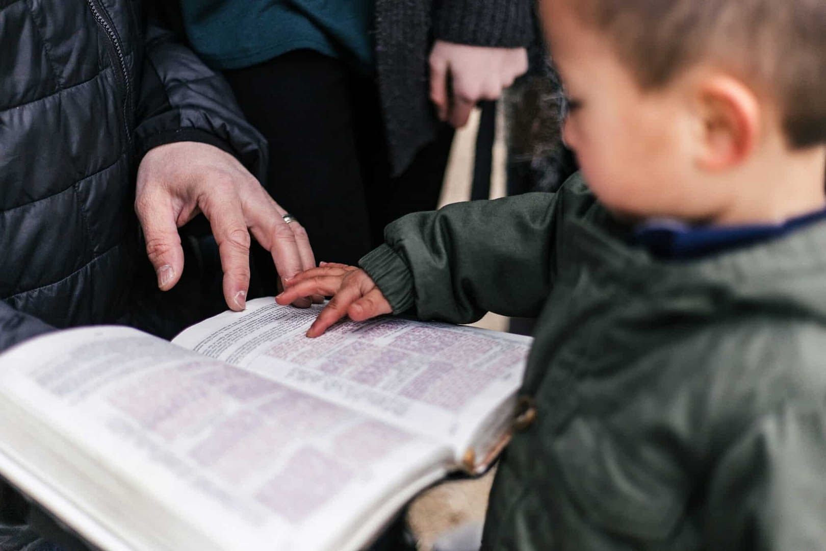 toddler pointing in bible