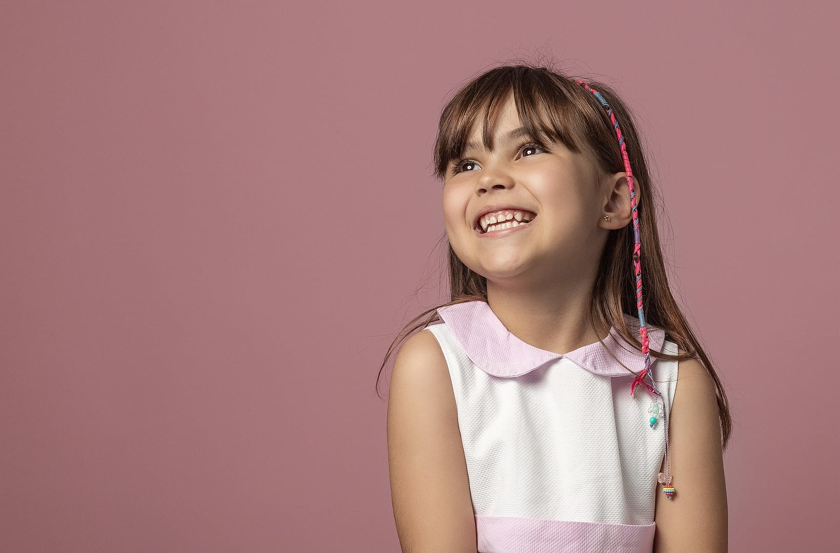 smiling girl with pink background