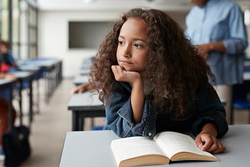 young girl thoughtfully looking