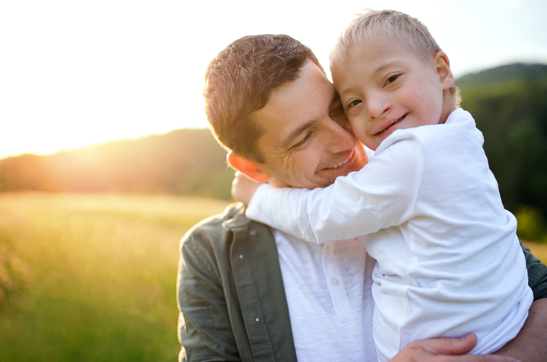 father holding son with down syndrome