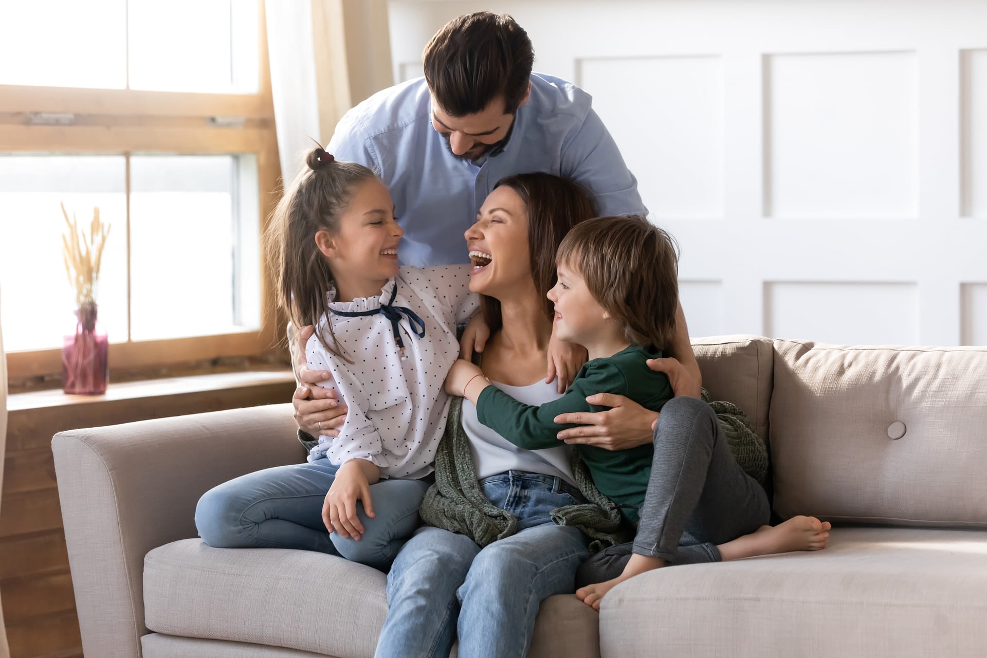 family laughing on couch