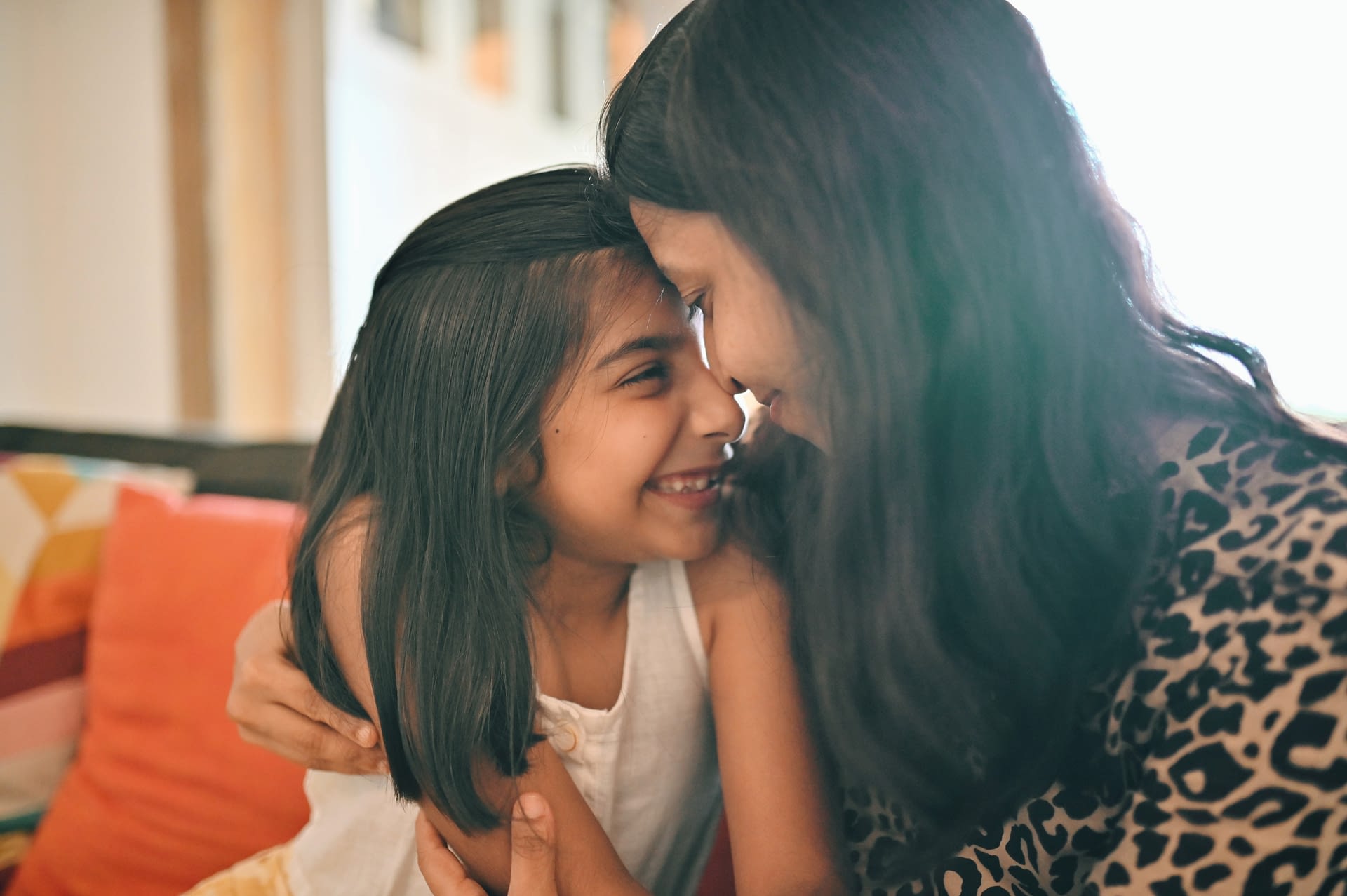 mom and daughter closely embracing
