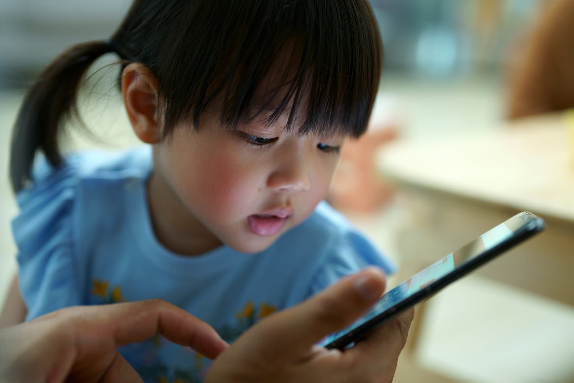young asian girl looking at phone