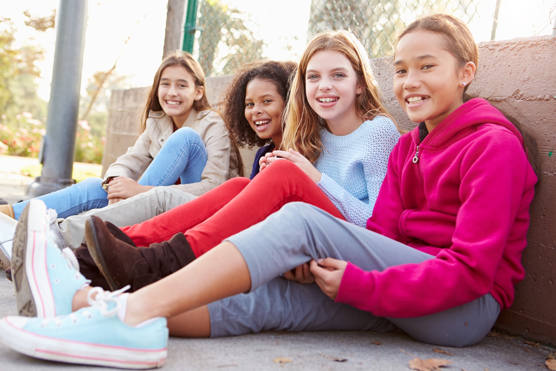 group of friends sitting on the ground
