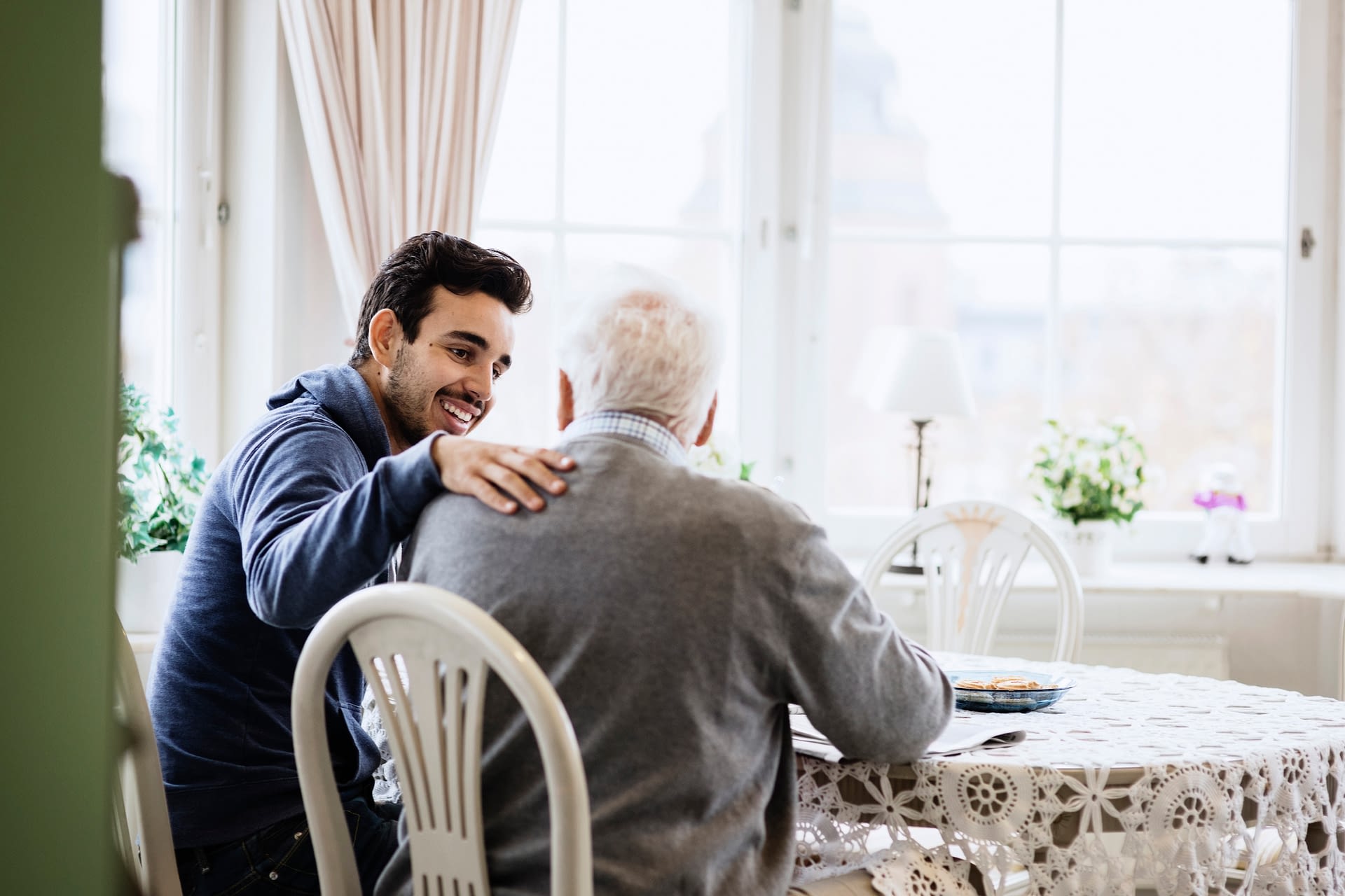 grandfather and grandson sitting at a table