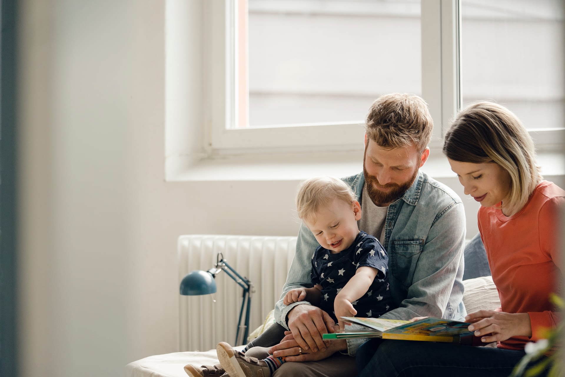 family reading books on the couch